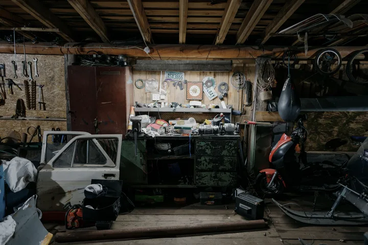 A garage packed to the walls with tools, tyres and stored boxes